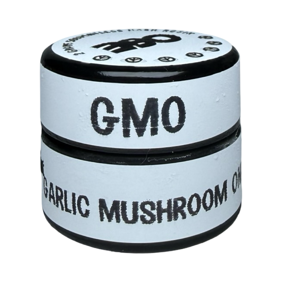 Side-angle view of Oil and Eve GMO cold cure hash rosin 2g jar showing strain name on label